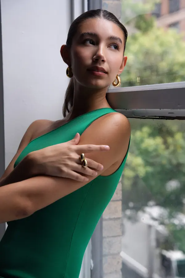 Window-light portrait of a woman in a green dress